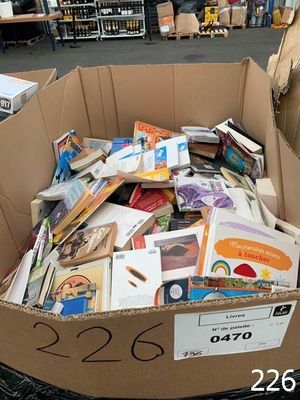 a cardboard box full of books in the middle of a store