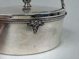 a silver container with a handle on a white table