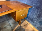 a wooden desk with a book on top of it