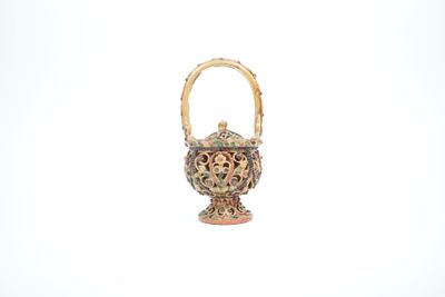 a small vase with a handle on a white surface