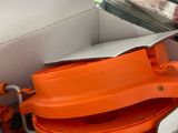 an orange bowl sitting inside of a box on the floor