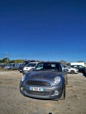 cars parked in a parking lot with a blue sky in the background