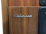 a close up of a speaker on a wooden surface