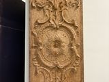 a wooden panel with a decorative design on it