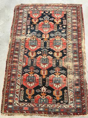 an antique persian rug with geometric design
