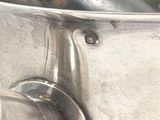 a large metal bowl with a handle on it