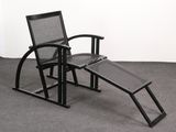 a black chair with a foot rest on the floor