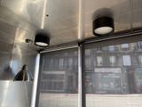 two lamps hanging from the ceiling of a food truck