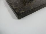a statue of a man sitting on top of a box
