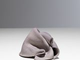 grey cloth on a white surface with a gray background