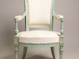 an image of a green chair with a white upholstered seat