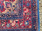 a close up of a rug on the ground with a cat laying on it