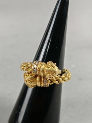 a close up of a gold ring on a black cone