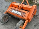 a picture of an orange lawn mower sitting on the ground