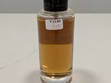an image of a bottle of perfume sitting on top of a table