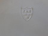 an image of a white plate with a shield on it