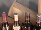 several bottles of wine are lined up in a row on a table