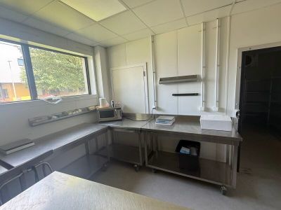 a kitchen with a sink, stove, cabinets, and a window