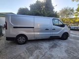 a silver van parked in a parking lot next to a building