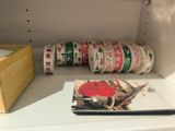 many rolls of tape sitting on a shelf next to a book