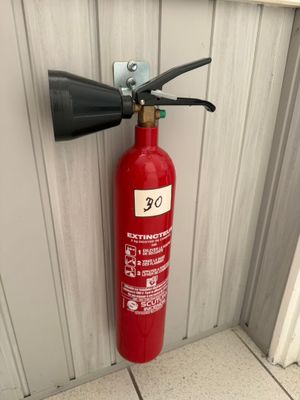 a fire extinguisor attached to a wall