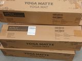 boxes of yoga mats stacked on top of each other on the floor