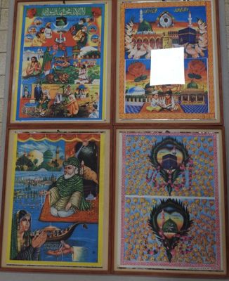 four framed pictures of asian art hanging on a wall in a room