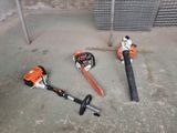 two chainsaws that are laying on the ground
