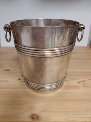 silver plated ice bucket with handles on wooden table