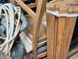 a pile of wooden chairs and other items in the back of a truck