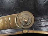 a close up of a black hat with a gold buckle