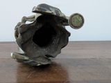 a small metal object sitting on a wooden table