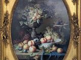 tableau représentant une nature morte avec des fruits sur une table, dans un cadre doré