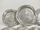 several pieces of silverware sitting on top of a white surface