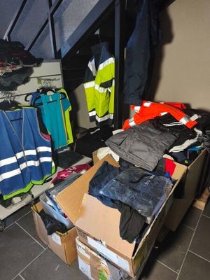 a pile of clothing on a carton in a room