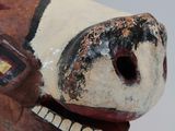 a close up of a cow head with a pipe sticking out of it ' s mouth