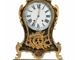 a clock that is hanging on the wall with a bird on it
