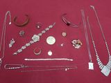 many different types of jewelry on a red surface