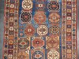 un vieux tapis aux couleurs et aux motifs variés
