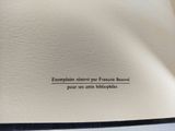 a close up of an open book with writing on it
