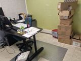 a desk with a computer and a chair in a room