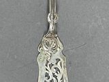 a silver spoon with a silver handle on a table