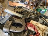 an image of a cluttered garage with tools on the floor