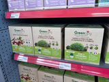 many boxes of green tea on the shelf in the store