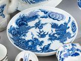 a blue and white plate with a dragon design on it