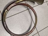 a horn and a hose on the floor of a bathroom