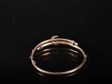 a close up of a gold ring on a black surface