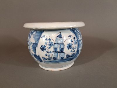 a blue and white vase with a bird on it