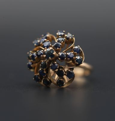un gros plan d'une bague en or sertie de pierres bleues