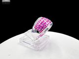 pink and white diamond ring on a clear stand on a white table